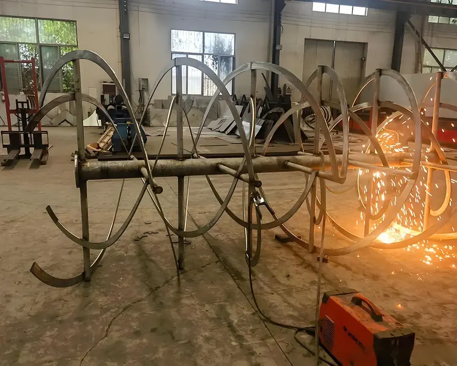 Ribbon flights being welded onto the agitator shaft