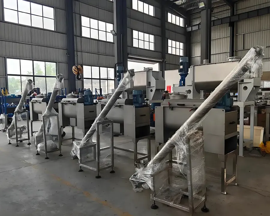 Row of ribbon mixers with screw conveyors assembled at the Saturn Machinery works